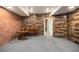 Finished basement with brick and wood paneling, gray carpet, table, and chairs at 120 Fountain Oak, Villa Rica, GA 30180