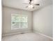 The interior of a simple bedroom with carpet and window at 120 Fountain Oak, Villa Rica, GA 30180