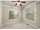 A simple yet comfortable bedroom with two windows for natural light and a ceiling fan at 120 Fountain Oak, Villa Rica, GA 30180