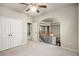 Bright upstairs bedroom features an arched opening and a view of the second story staircase at 120 Fountain Oak, Villa Rica, GA 30180
