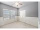 A bedroom with modern wainscoting, neutral walls, and a ceiling fan at 120 Fountain Oak, Villa Rica, GA 30180