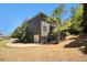 Two-story home featuring a garage and metal fence on a well-landscaped lawn under a clear blue sky at 120 Fountain Oak, Villa Rica, GA 30180