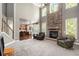 Spacious living room featuring a floor-to-ceiling stone fireplace and large windows at 120 Fountain Oak, Villa Rica, GA 30180