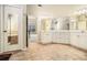 Bright main bathroom with double sink vanity, white cabinets, and open doorway to bedroom at 120 Fountain Oak, Villa Rica, GA 30180