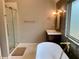 Spa-like bathroom with a sleek glass shower, freestanding tub, and modern fixtures at 1370 Long Acre Dr, Loganville, GA 30052