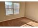 Bedroom with neutral carpet, neutral colored walls and a window with blinds at 1370 Long Acre Dr, Loganville, GA 30052
