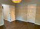 Bedroom with wood floors, two white paneled doors, neutral colored walls and a modern light fixture at 1370 Long Acre Dr, Loganville, GA 30052