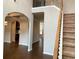 Open-concept entryway with hardwood floors and staircase, creating a bright and inviting space at 1370 Long Acre Dr, Loganville, GA 30052