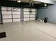 Spacious two car garage with epoxy flooring and ample room for parking and storage at 1370 Long Acre Dr, Loganville, GA 30052