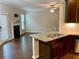 Spacious kitchen with granite counters, stainless steel appliances, and breakfast bar overlooking the living room at 1370 Long Acre Dr, Loganville, GA 30052