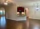 Bright living room featuring hardwood floors, ceiling fan, and seamless transition to the kitchen at 1370 Long Acre Dr, Loganville, GA 30052