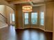 Open-concept living room with large windows and hardwood floors at 1370 Long Acre Dr, Loganville, GA 30052