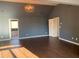 Spacious living room showcases an open layout, complemented by hardwood floors and modern lighting fixture at 1370 Long Acre Dr, Loganville, GA 30052