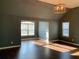 Sunlit living room boasts hardwood floors, large windows, and neutral color scheme at 1370 Long Acre Dr, Loganville, GA 30052