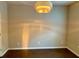 Living room with wood floors, neutral paint and a modern light fixture at 1370 Long Acre Dr, Loganville, GA 30052