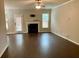 Open-concept living room featuring a fireplace and large windows for plenty of natural light at 1370 Long Acre Dr, Loganville, GA 30052