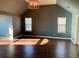 Inviting living room featuring hardwood floors, decorative lighting, and large windows for ample natural light at 1370 Long Acre Dr, Loganville, GA 30052