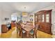 Bright dining room with hardwood floors, a formal dining set, and hutch at 4206 Cornell Nw Xing, Kennesaw, GA 30144