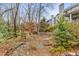 Landscaped backyard with stone retaining walls and mature trees at 44 Whitlock Sw Sq, Marietta, GA 30064