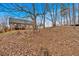 House and backyard view with steps leading up at 65 Centerport Dr, White, GA 30184