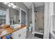 Modern bathroom with wood vanity and shower at 65 Centerport Dr, White, GA 30184
