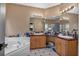 Bathroom with double vanity and bathtub at 65 Centerport Dr, White, GA 30184