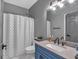 Updated bathroom with blue vanity and gray walls at 65 Centerport Dr, White, GA 30184