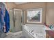 Bathroom with shower, bathtub, and window at 65 Centerport Dr, White, GA 30184