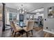 Open concept dining room features a glass table and modern chandelier at 65 Centerport Dr, White, GA 30184