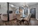 Elegant dining room with a glass-top table, neutral colored chairs, and a modern chandelier at 65 Centerport Dr, White, GA 30184