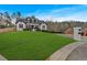Exterior view of the house with a large front yard and a brick mailbox at 65 Centerport Dr, White, GA 30184