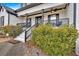 Charming front porch with black railings, columns, and lush landscaping at 65 Centerport Dr, White, GA 30184