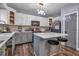 Modern kitchen with gray island and white cabinets at 65 Centerport Dr, White, GA 30184