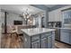 Modern kitchen with gray island and white cabinets at 65 Centerport Dr, White, GA 30184
