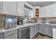 Modern kitchen with gray and white cabinets and quartz countertops at 65 Centerport Dr, White, GA 30184