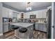 Modern kitchen with gray island and white cabinets at 65 Centerport Dr, White, GA 30184