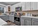 Modern kitchen with gray and white cabinets, and gold accents at 65 Centerport Dr, White, GA 30184