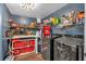 Basement laundry room with washer, dryer, and ample storage shelves at 65 Centerport Dr, White, GA 30184