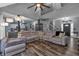 Large living room with sectional sofa, hardwood floors, and a view to the kitchen at 65 Centerport Dr, White, GA 30184