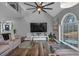 Living room with vaulted ceiling, hardwood floors, and a large window at 65 Centerport Dr, White, GA 30184