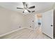 Bedroom with ceiling fan, wood-look floors, and view of the hallway at 1131 Orr Rd, Jonesboro, GA 30238
