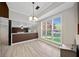 Dining area featuring a large window with views of the backyard and a modern chandelier at 1131 Orr Rd, Jonesboro, GA 30238