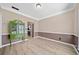 Dining room with neutral paint, wainscoting, light wood floors and a display cabinet at 1131 Orr Rd, Jonesboro, GA 30238