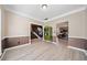 Dining room with neutral paint, wainscoting, light wood floors, stairs and kitchen views at 1131 Orr Rd, Jonesboro, GA 30238