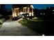 Long driveway leading to a well-lit house, surrounded by landscaped yard and mature trees at 1131 Orr Rd, Jonesboro, GA 30238