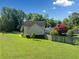 Back of house with large yard, wooden fence, and tree at 1131 Orr Rd, Jonesboro, GA 30238