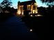 Beautifully lit home at dusk with manicured lawn, driveway and lush green landscaping at 1131 Orr Rd, Jonesboro, GA 30238