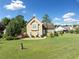 Tan house with stone accents, landscaped yard, and a driveway at 1131 Orr Rd, Jonesboro, GA 30238