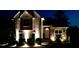 Charming two-story home with stone accents, manicured landscaping, and warm exterior lighting at 1131 Orr Rd, Jonesboro, GA 30238