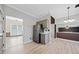 Open kitchen with stainless steel refrigerator, gray cabinets, gray walls and light wood floors at 1131 Orr Rd, Jonesboro, GA 30238